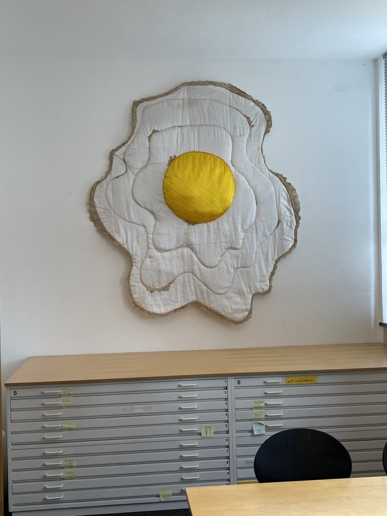 Ingrid Honneth: Spiegelei-Relief Alltäglichkeit als Ikone: Ein monumentales Spiegelei, genäht und gepolstert, oszilliert zwischen Pop, Körperlichkeit und sakraler Form. Transzendenz aus Textil. Foto: Edda Rössler